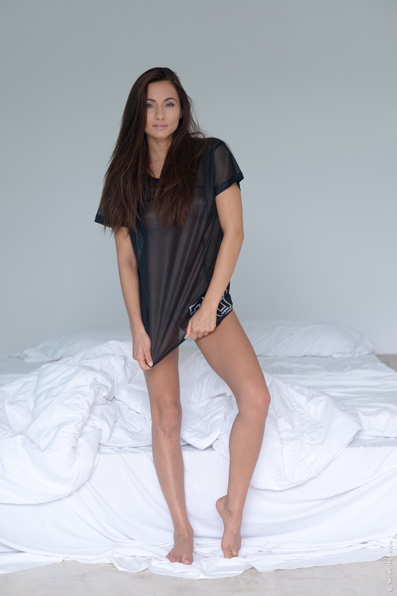 Michaela Isizzu shows off her pink pussy by spreading her legs in a long shirt