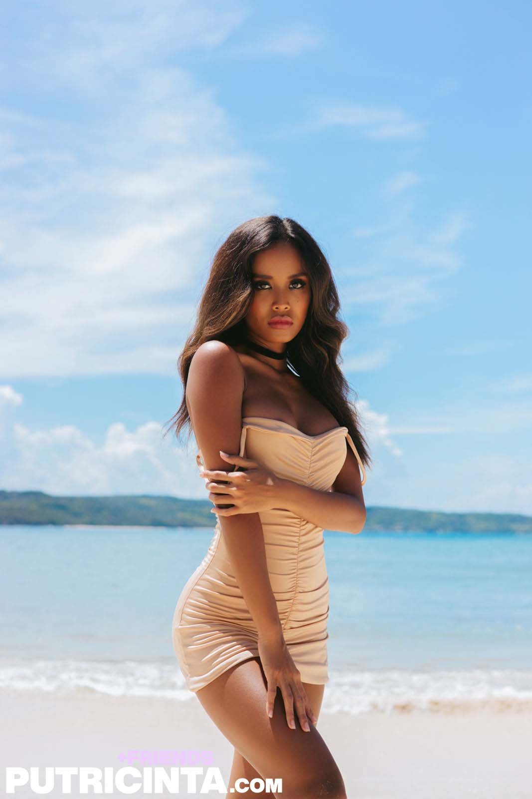 Putri Cinta seductively slips out of her dress and strikes a pose on the seashore