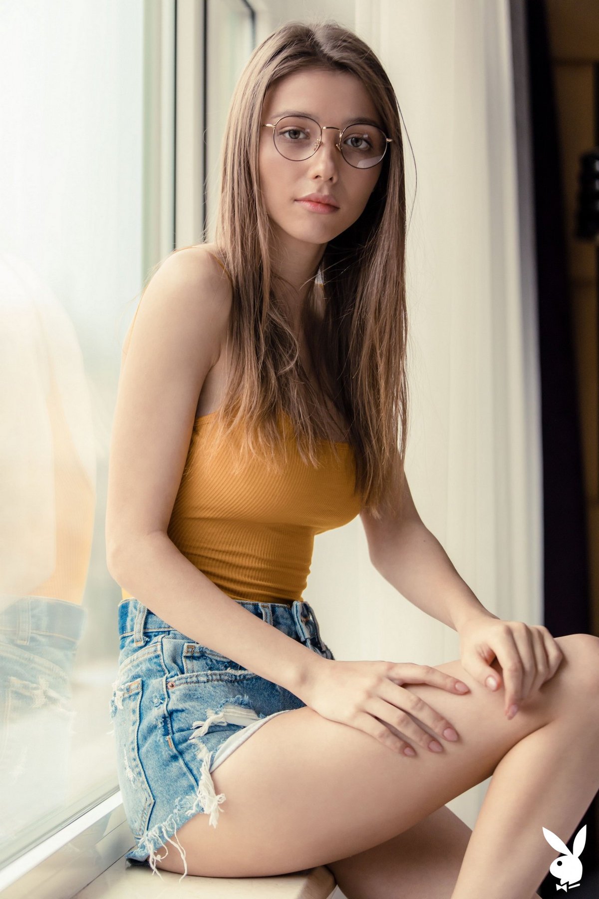 Mila Azul looks sexy and innocent while stripping with her glasses on