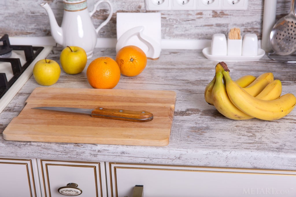 Renzi - Redhead babe cuts up fruit and strips along the way