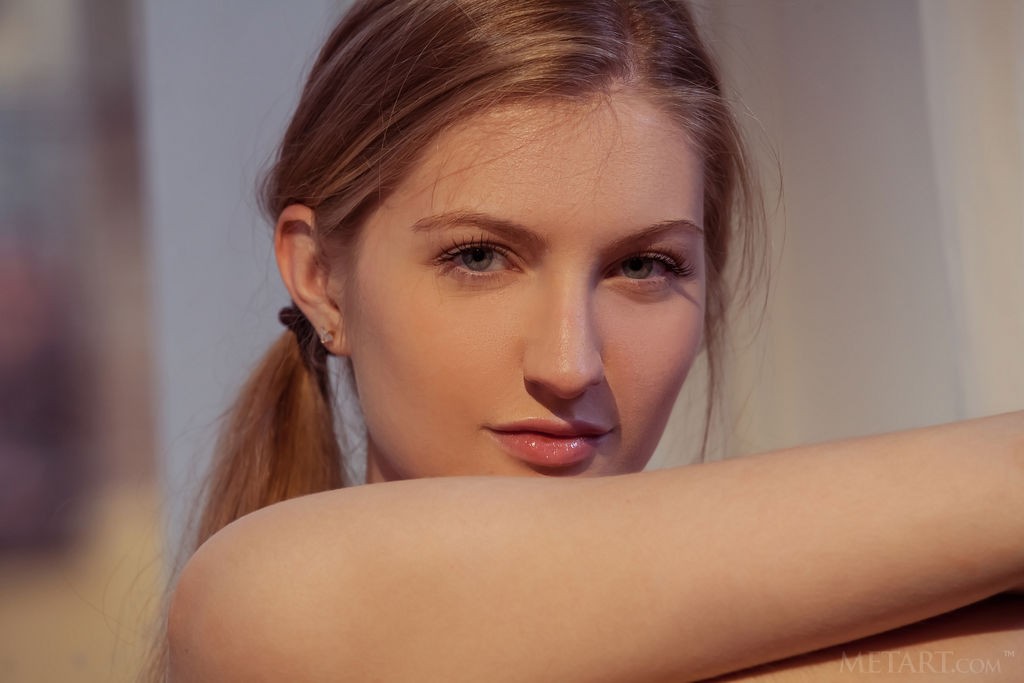 Bretona - Skinny blonde barely legal model striping on an armchair