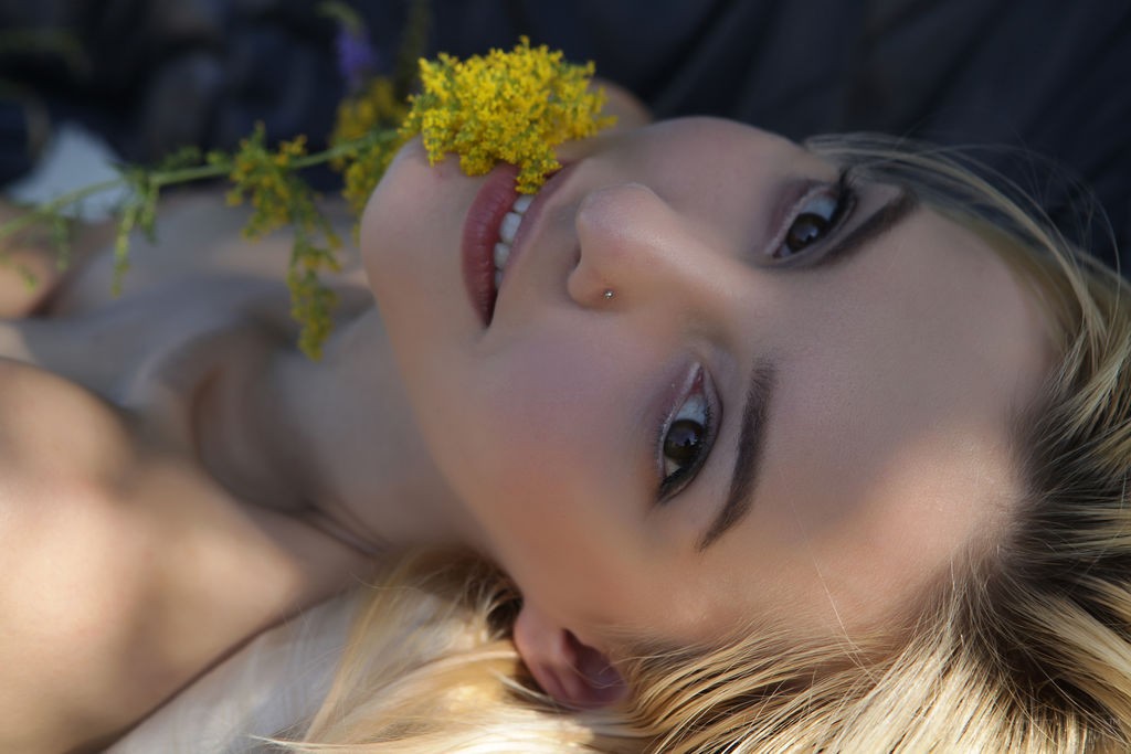 Kira W - Skinny, beautiful blonde teases nipples with some flowers