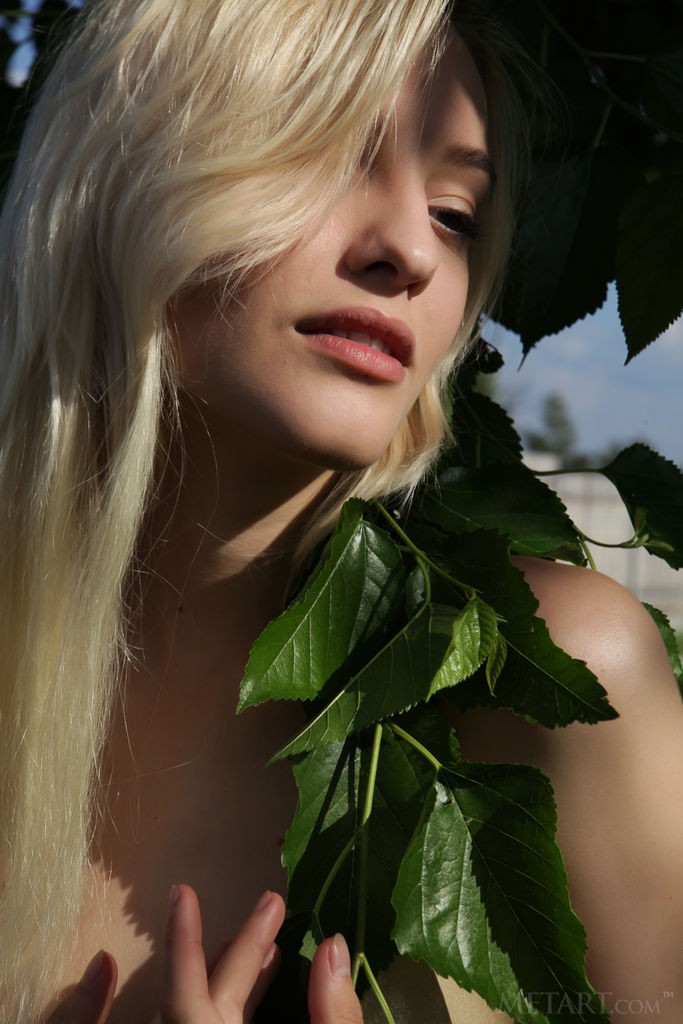 Kira W - Skinny, beautiful blonde teases nipples with some flowers