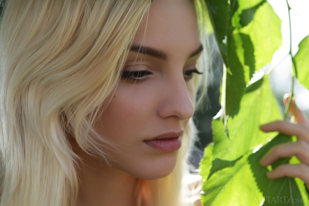 Kira W - Skinny, beautiful blonde teases nipples with some flowers
